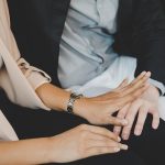 Closeup of man putting his hand on woman's lap against her will